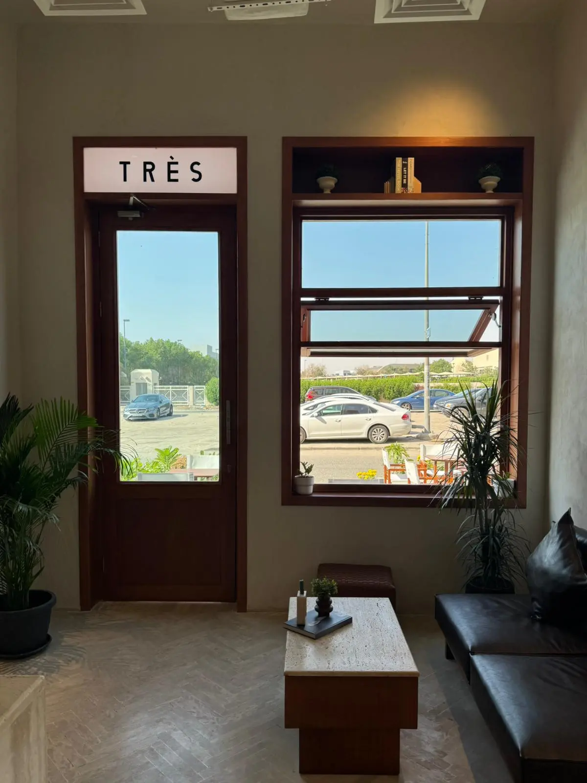Coffee beans and accessories displayed on shelves at Très Café